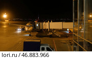 Close view of aircraft fuselage near the entering baggage door, at night. Редакционное фото, фотограф David Kashakhi / Фотобанк Лори
