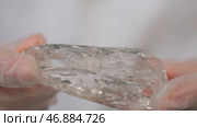 Male hand holding a fragment of rock crystal mineral. Стоковое фото, фотограф David Kashakhi / Фотобанк Лори