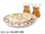 Вкусная халва тахини с фисташками и стаканами турецкого чая на белом фоне. Стоковое фото, фотограф Pixel_shot / Фотобанк Лори