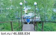 Man hiking in the forest as he climbs on the stair - travel and hiking. Стоковое фото, фотограф David Kashakhi / Фотобанк Лори
