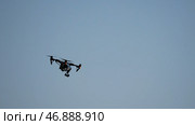 Flying quadrocopter drone in the sky with mounted digital camera for video and photo productions. Редакционное фото, фотограф David Kashakhi / Фотобанк Лори