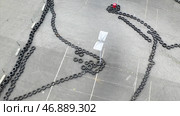 Aerial top view of the karting track made of old black car tires, motorsport concept. Стоковое фото, фотограф David Kashakhi / Фотобанк Лори
