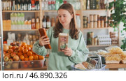 Teen girl selects suitable product from nougat assortment. Стоковое видео, видеограф Яков Филимонов / Фотобанк Лори