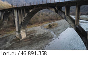 Aerial of an old abandoned mossy bridge over the almost dried out river, ecology problems and climate changing concept. Стоковое фото, фотограф David Kashakhi / Фотобанк Лори