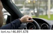 Man in grey shirt with black watch driving car on the road, modern car interior. Стоковое фото, фотограф David Kashakhi / Фотобанк Лори