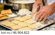 Passover preparation with matzah crackers and handmade matzo balls. Стоковое AI-изображение, AI-художник Анастасия Золотницкая / Фотобанк Лори