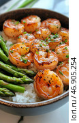 Delicious Shrimp and Grits With Asparagus Served in a Bowl. Стоковое AI-изображение, AI-художник Юлия Гапеенко / Фотобанк Лори