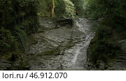 Mountainous cold stream flowing down the stony slope. Стоковое фото, фотограф David Kashakhi / Фотобанк Лори