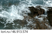 Beautiful view of the sea beating against the rocks.Creative.Beautiful large mountains on which there are houses located next to the undulating sea. Стоковое фото, фотограф David Kashakhi / Фотобанк Лори