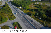 A bright summer green forest with a large forest and a road with cars nearby and in the distance you can see the road and the river. Стоковое фото, фотограф David Kashakhi / Фотобанк Лори