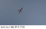 Bottom view of a helicopter carries a cargo of military supplies in flight hanging with a rope from the barycentric hook. Стоковое фото, фотограф David Kashakhi / Фотобанк Лори