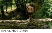 Creative.People in swimsuits walking on the lake in the mountains and green thickets of trees are visible. Стоковое фото, фотограф David Kashakhi / Фотобанк Лори