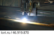 The laser cutter machine while cutting the sheet metal with the sparking light. Стоковое фото, фотограф David Kashakhi / Фотобанк Лори