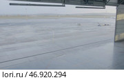 Hangar for aircraft with large open gate at sunny summer day. Стоковое фото, фотограф David Kashakhi / Фотобанк Лори