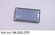 Warsaw, Poland - 11.20.2020: Close up of a new Apple Iphone 12 pro max in a box. Редакционное фото, фотограф David Kashakhi / Фотобанк Лори