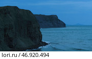 Stunning seascape with a steep cliff on dark blue sky background. Стоковое фото, фотограф David Kashakhi / Фотобанк Лори