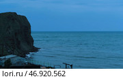 Stunning seascape with a steep cliff on dark blue sky background. Стоковое фото, фотограф David Kashakhi / Фотобанк Лори
