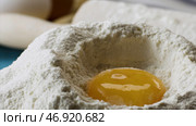 Yolk Falls Into the Flour in Slow motion, close up. Стоковое фото, фотограф David Kashakhi / Фотобанк Лори