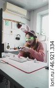 Young esports enthusiast enjoys gaming session in decorated Easter room. Bunny ears, LED glasses, and gaming gear create unique mix of competition and holiday cheer. Стоковое видео, видеограф Енваев Андрей / Фотобанк Лори