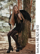 Enigmatic Teen Girl Model With Angelic Wings Poses by a Serene Lakeside in Nature at Golden Hour. Стоковое фото, фотограф Aleksandr Golubev / Фотобанк Лори