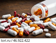 Prescription medication and pills spilled on table. Стоковое AI-изображение, AI-художник Елена Болотина / Фотобанк Лори