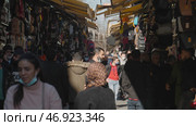 Turkey, Istanbul-December, 2020: Man in bazaar on background crowds of people. Редакционное фото, фотограф David Kashakhi / Фотобанк Лори