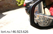 Blind Spot Monitoring system warning light icon in side view mirror of a modern vehicle. Стоковое фото, фотограф David Kashakhi / Фотобанк Лори