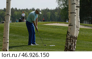 Golfers hit sweeping golf course in the summer. Стоковое фото, фотограф David Kashakhi / Фотобанк Лори