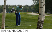 Golfers hit sweeping golf course in the summer. Стоковое фото, фотограф David Kashakhi / Фотобанк Лори