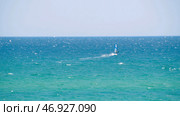 Windsurfer in the sea, man on windsurf conquering the waves, enjoying extreme sport, active lifestyle, happy summer vacation. Стоковое фото, фотограф David Kashakhi / Фотобанк Лори