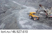Excavator falls asleep rubble in dumper on outdoor quarry in extraction of minerals. Стоковое фото, фотограф David Kashakhi / Фотобанк Лори