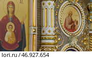 Russia - Moscow, 25 March 2020: Interior of a decorative orthodox church with beautiful fresco covering wall with icons, religion concept. Редакционное фото, фотограф David Kashakhi / Фотобанк Лори