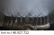 Metal pipes of the working fountain with streams of water rising into the air from many nozzles. Стоковое фото, фотограф David Kashakhi / Фотобанк Лори