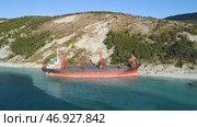 Aerial top view of an empty, red barge moored near the beautiful blue sea shore. Стоковое фото, фотограф David Kashakhi / Фотобанк Лори