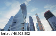 Bottom view of a twisted skyscraper on blue cloudy sky background. Редакционное фото, фотограф David Kashakhi / Фотобанк Лори