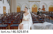 Beautiful newlyweds, woman in white dress and a man in suit before ceremony. Стоковое фото, фотограф David Kashakhi / Фотобанк Лори