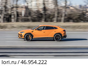 Lamborghini Urus car driving in city with motion blur, view from the side. Редакционное фото, фотограф Константин Григорьев / Фотобанк Лори