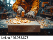 A carpenter at work, planing a wooden workpiece with a plane. Shavings and sawdust fly through the air, creating a dynamic effect. The craftsman's working hands are protected by durable gloves, and his clothes are covered in wood dust, which emphasizes the labor-intensive nature of the process. The warm lighting of the workshop and the rich shades of wood create an atmosphere of coziness and craftsmanship. In the depth of the frame, you can see elements of the workshop with tools and equipment. Стоковое AI-изображение, AI-художник Анна Кривицкая / Фотобанк Лори