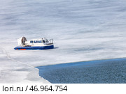 Baikal Lake in spring. Top view of the Khivus hovercraft carrying passengers to Olkhon Island during ice drift on a windy April day. Natural background. Unusual travels and adventures. Стоковое фото, фотограф Виктория Катьянова / Фотобанк Лори