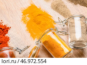 Перевёрнутые банки с разными специями на деревянном фоне. Стоковое фото, фотограф Pixel_shot / Фотобанк Лори