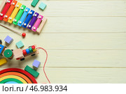 Игрушечный поезд со строительными блоками и ксилофоном на желтом деревянном фоне. Стоковое фото, фотограф Pixel_shot / Фотобанк Лори