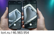 China, Beijing - September 15, 2023: Close-up of iPhone screens in comparison of cameras. Редакционное фото, фотограф David Kashakhi / Фотобанк Лори
