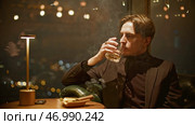 Attractive young man smokes cigar cinematically. Стоковое фото, фотограф David Kashakhi / Фотобанк Лори