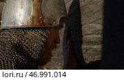 Close up side view of a man in very heavy headdress, middle ages armor concept. Стоковое фото, фотограф David Kashakhi / Фотобанк Лори