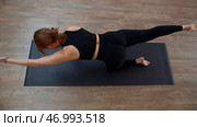 Top view of slim lady doing yoga exercise on a mat. Стоковое фото, фотограф David Kashakhi / Фотобанк Лори