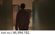 Young man in pink oversize hoodie at the hotel. Стоковое фото, фотограф David Kashakhi / Фотобанк Лори