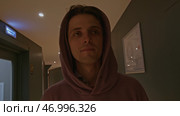 Young man in pink oversize hoodie at the hotel. Стоковое фото, фотограф David Kashakhi / Фотобанк Лори