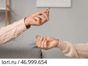 Зрелая пара обменивается обручальными кольцами дома, крупным планом. Концепция развода. Стоковое фото, фотограф Pixel_shot / Фотобанк Лори