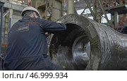 Worker with non-destructive testing device on metal part. Стоковое фото, фотограф David Kashakhi / Фотобанк Лори