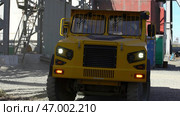 A Robust Heavy Duty Yellow Truck Operating Within a Challenging Industrial Setting. Стоковое фото, фотограф David Kashakhi / Фотобанк Лори